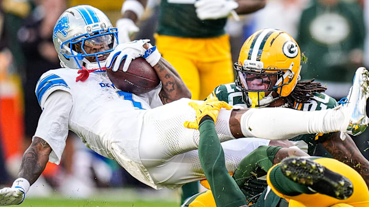 Detroit Lions wide receiver Jameson Williams (1) makes a catch against Green Bay Packers safety Javon Bullard (20) 