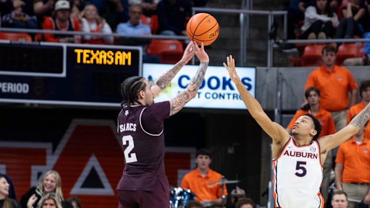 Texas A&M Aggies guard Pop Isaacs (2) takes a jump shot over Auburn Tigers guard Kaden Magwood (5) as Auburn Tigers take on Texas A&M Aggies at Neville Arena in Auburn, Ala. on Tuesday, Jan. 6, 2026. Texas A&M Aggies defeated Auburn Tigers 90-88.