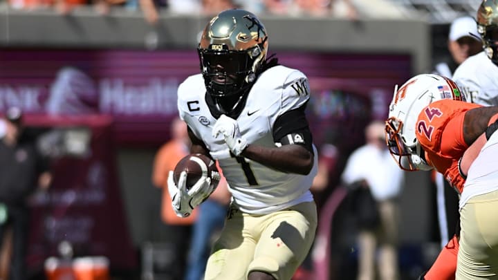 Oct 4, 2025; Blacksburg, Virginia, USA;  Wake Forest Demon Deacons running back Demond Claiborne (1) runs the ball during the first quarter against the Virginia Tech Hokies at Lane Stadium.