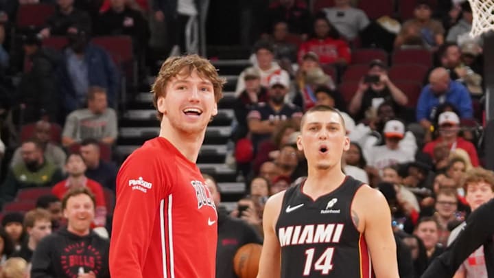 Jan 8, 2026; Chicago, Illinois, USA; Chicago Bulls forward Matas Buzelis (14) and Miami Heat guard Tyler Herro (14) take backward half courts shots as the game against the Miami Heat is delayed because of condensation on the court due to humidity and rain at United Center. Mandatory Credit: David Banks-Imagn Images