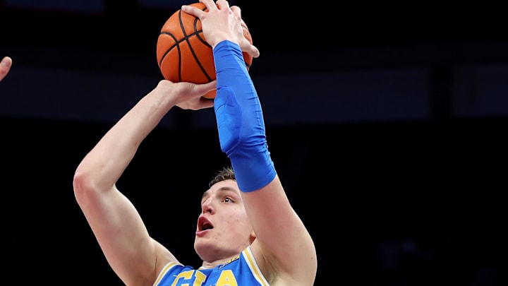 Jan 17, 2026; Columbus, Ohio, USA; UCLA Bruins forward Tyler Bilodeau (34) shoots the ball as Ohio State Buckeyes center Christoph Tilly (13) defends during the first half at Value City Arena. Mandatory Credit: Joseph Maiorana-Imagn Images
