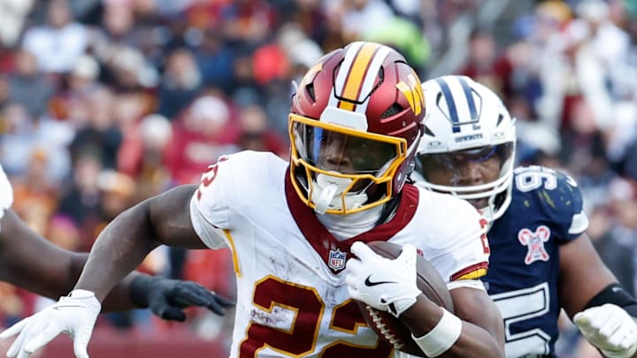 Washington Commanders running back Jacory Croskey-Merritt carries the ball defended by Dallas Cowboys defender James Houston. Washington Commanders running back Jacory Croskey-Merritt carries the ball defended by Dallas Cowboys defender James Houston.