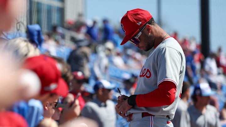 Mar 2, 2025; Dunedin, Florida, USA; Philadelphia Phillies outfielder Justin Crawford (80) signs autographs for fans before a game against the Toronto Blue Jays during spring training at TD Ballpark.