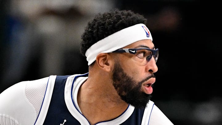 Dallas Mavericks forward Anthony Davis looks to move the ball past Philadelphia 76ers center Adem Bona.