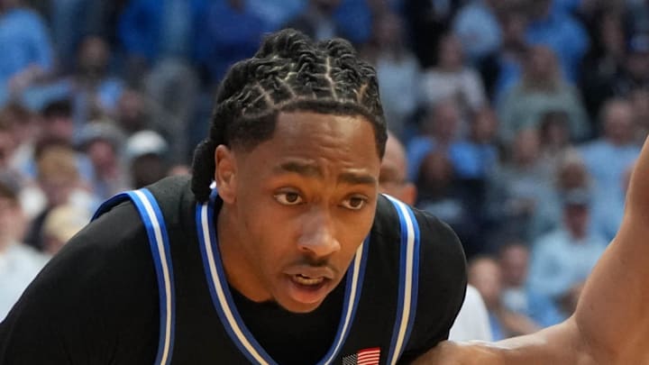 Feb 7, 2026; Chapel Hill, North Carolina, USA;  Duke Blue Devils guard Isaiah Evans (3) with the ball as North Carolina Tar Heels guard Seth Trimble (7) defends in the first  half at Dean E. Smith Center. Mandatory Credit: Bob Donnan-Imagn Images