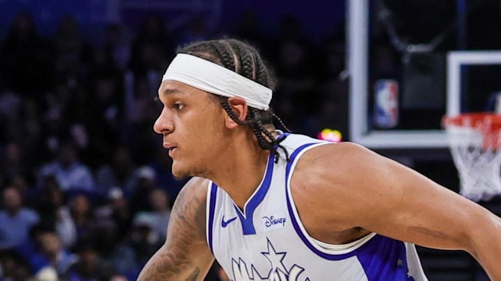 Orlando Magic forward Paolo Banchero handles the ball in front of Utah Jazz guard Isaiah Collier.