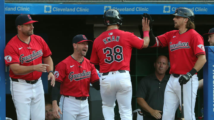 Cleveland Guardians left fielder Steven Kwan (38) is welcomed back to the dugout after scoring on a hit by José Ramírez during the first inning of an MLB game against the Seattle Mariners at Progressive Field, Wednesday, June 19, 2024, in Cleveland, Ohio.