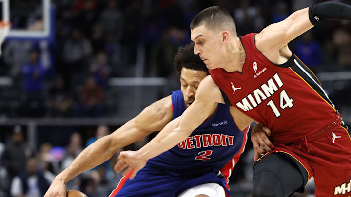 Dec 16, 2024; Detroit, Michigan, USA; Detroit Pistons guard Cade Cunningham (2) dribbles as Miami Heat guard Tyler Herro (14) defends in the second half at Little Caesars Arena. Mandatory Credit: Rick Osentoski-Imagn Images