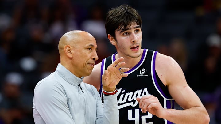 Dec 11, 2025; Sacramento, California, USA; Sacramento Kings head coach Doug Christie talks with center Maxime Raynaud (42) during the fourth quarter against the Denver Nuggets at Golden 1 Center.