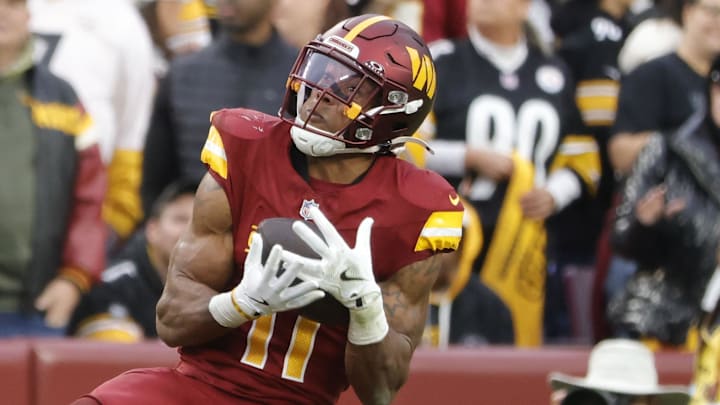 Nov 10, 2024; Landover, Maryland, USA; Washington Commanders safety Jeremy Chinn (11) intercepts a pass intended for Pittsburgh Steelers wide receiver George Pickens (14) during the second half at Northwest Stadium. Mandatory Credit: Amber Searls-Imagn Images
