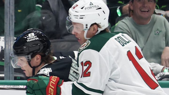 Apr 18, 2026; Dallas, Texas, USA; Dallas Stars defenseman Miro Heiskanen (4) is checks by Minnesota Wild left wing Matt Boldy (12) in the first period in game one of the first round of the 2026 Stanley Cup Playoffs at American Airlines Center. Mandatory Credit: Thomas Shea-Imagn Images