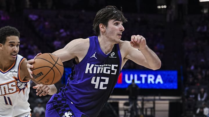 Mar 3, 2026; Sacramento, California, USA; Sacramento Kings center Maxime Raynaud (42) dribbles past Phoenix Suns forward Oso Ighodaro (11) during the fourth quarter at Golden 1 Center. Mar 3, 2026; Sacramento, California, USA; Sacramento Kings center Maxime Raynaud (42) dribbles past Phoenix Suns forward Oso Ighodaro (11) during the fourth quarter at Golden 1 Center.