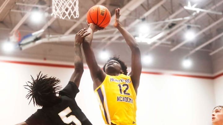 Montverde's Caleb Gaskins (12) gets fouled on a shot attempt against Whitehaven   s Kenton Smith (5) during a basketball game in the Winter Classic at the McDonald Insurance Arena on Friday, Feb. 09, 2024 in Bartlett, Tenn.