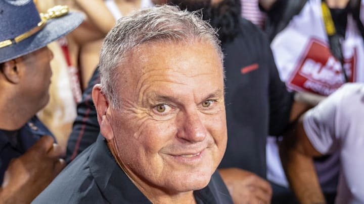 Arkansas Razorbacks coach Sam Pittman enjoys the moment as fans rush the field following the Hogs' 19-14 upset win over No. 4 Tennessee at Razorback Stadium on Oct. 5, 2024.