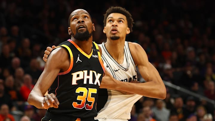 Dec 3, 2024; Phoenix, Arizona, USA; Phoenix Suns forward Kevin Durant (35) against San Antonio Spurs center Victor Wembanyama (1) in the first half of an NBA Cup game at Footprint Center.