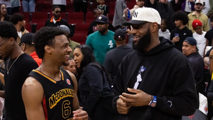 Mar 28, 2023; Houston, TX, USA; West guard Bronny James (6) with father LeBron James following the McDonald's All American Boy's high school basketball game at Toyota Center. 