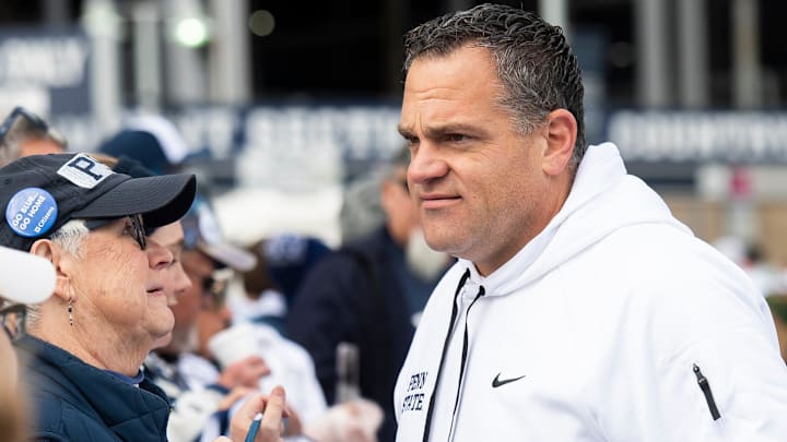 Penn State athletic director Pat Kraft talks with members of an alumni group outside of Beaver Stadium before an NCAA football game against Michigan Saturday, Nov. 11, 2023, in State College, Pa.