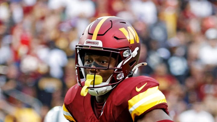 Washington Commanders wide receiver Terry McLaurin runs the ball as Las Vegas Raiders safety Isaiah Pola-Mao defends