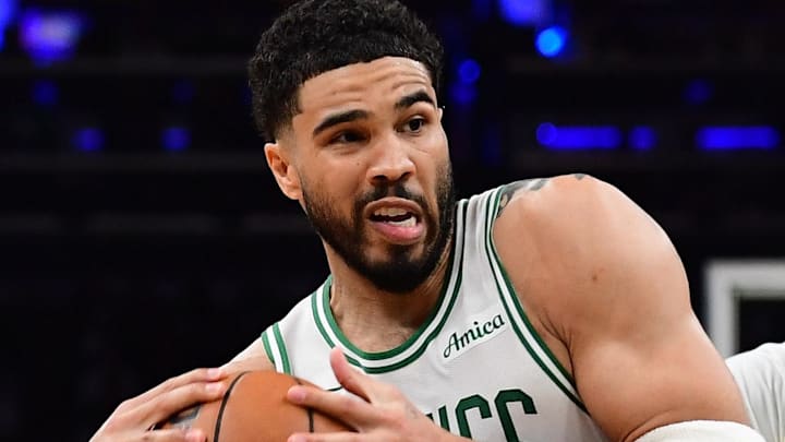 Apr 19, 2026; Boston, Massachusetts, USA; Boston Celtics forward Jayson Tatum (0) drives to the basket between Philadelphia 76ers forward Paul George (8) and center Andre Drummond (1) in the second half during game one of the first round of the 2026 NBA Playoffs at TD Garden. Mandatory Credit: Bob DeChiara-Imagn Images