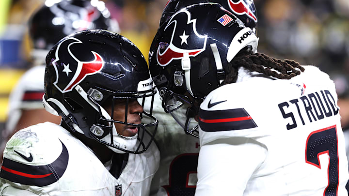 Jan 12, 2026; Pittsburgh, PA, USA; Houston Texans running back Woody Marks (27) and quarterback C.J. Stroud (7) celebrate after a touchdown during the second half of an AFC Wild Card Round game against the Pittsburgh Steelers at Acrisure Stadium. Mandatory Credit: Charles LeClaire-Imagn Images