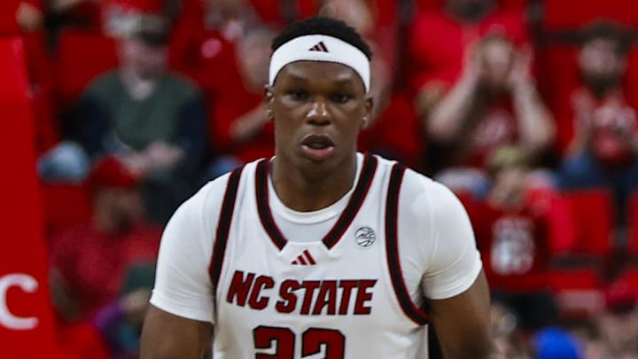 Dec 6, 2025; Raleigh, North Carolina, USA; NC State Wolfpack guard Tre Holloman (5) high fives forward Ven-Allen Lubin (22) and forward Darrion Williams (1) during the second half of the game against UNC Asheville Bulldogs at Lenovo Center. Mandatory Credit: Jaylynn Nash-Imagn Images