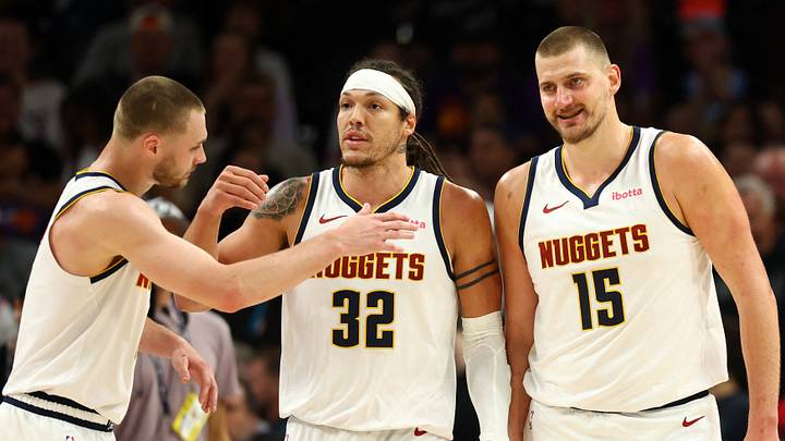 Mar 24, 2026; Phoenix, Arizona, USA; Denver Nuggets guard Christian Braun (0) celebrates with forward Aaron Gordon (32) and center Nikola Jokic (15) against the Phoenix Suns in the first half at Mortgage Matchup Center.
