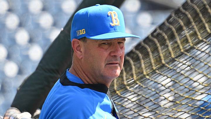 Jun 14, 2025; Omaha, Neb, USA;  UCLA Bruins head coach John Savage watches the team warm up before the game against the Murray State Races at Charles Schwab Field. Mandatory Credit: Steven Branscombe-Imagn Images