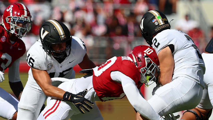 Oct 4, 2025; Tuscaloosa, Alabama, USA; Vanderbilt Commodores quarterback Diego Pavia (2) is tackled by Alabama Crimson Tide linebacker Justin Jefferson (10) during the first quarter at Saban Field at Bryant-Denny Stadium. Mandatory Credit: David Leong-Imagn Images