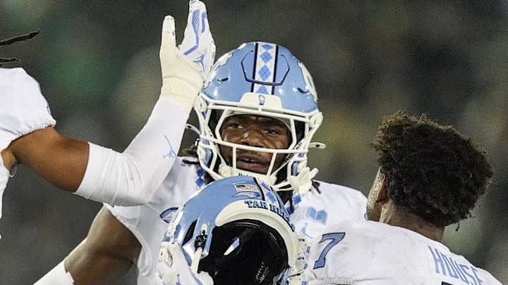 Sep 6, 2025; Charlotte, North Carolina, USA; North Carolina Tar Heels defensive back Greg Smith (12) celebrates his interception with teammates during the second half against the Charlotte 49ers at Jerry Richardson Stadium. Mandatory Credit: Jim Dedmon-Imagn Images