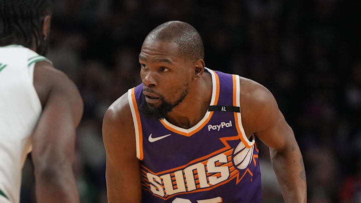 Mar 26, 2025; Phoenix, Arizona, USA; Phoenix Suns forward Kevin Durant (35) shields the ball from Boston Celtics guard Jaylen Brown (7) during the first half at Footprint Center. Mandatory Credit: Rick Scuteri-Imagn Images