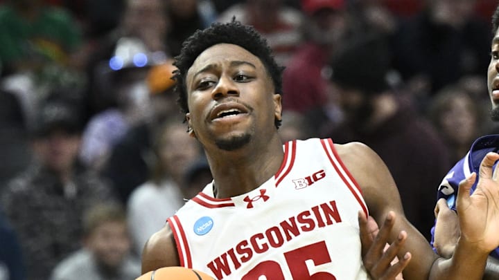 Mar 19, 2026; Portland, OR, USA; Wisconsin Badgers guard John Blackwell (25) controls the ball against High Point Panthers forward Terry Anderson (5) during the first half of a first round game of the men's 2026 NCAA Tournament at Moda Center. Mandatory Credit: Craig Strobeck-Imagn Images