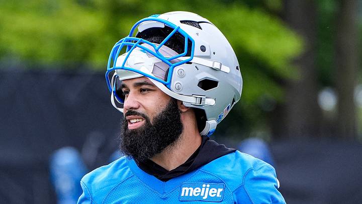Detroit Lions assistant wide receivers coach Bruce Gradkowski, left, talks to running back Jacob Saylors (25) before OTAs at Meijer Performance Center in Allen Park on Thursday, June 11, 2026.
