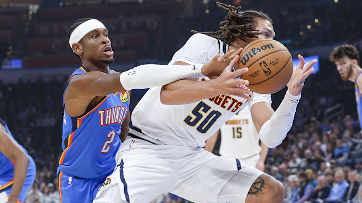 Oct 29, 2023; Oklahoma City, Oklahoma, USA; Oklahoma City Thunder guard Shai Gilgeous-Alexander (2) works to steal the ball from Denver Nuggets forward Aaron Gordon (50) on a drive during the first quarter at Paycom Center. Mandatory Credit: Alonzo Adams-Imagn Images