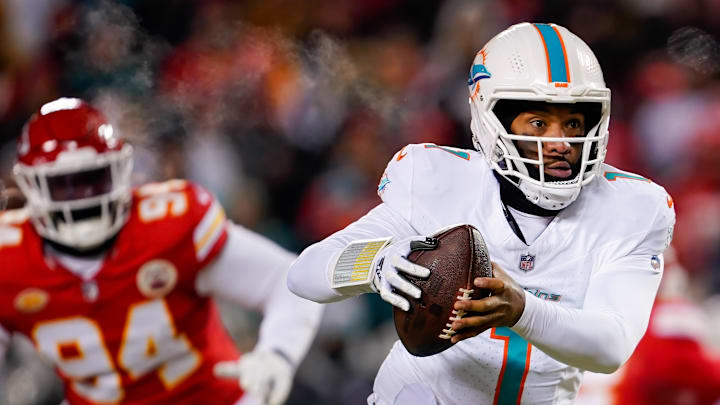 Jan 13, 2024; Kansas City, Missouri, USA; Miami Dolphins quarterback Tua Tagovailoa (1) and Kansas City Chiefs defensive end Malik Herring (94) during the first half in a 2024 AFC wild card game at GEHA Field at Arrowhead Stadium. Mandatory Credit: Jay Biggerstaff-Imagn Images