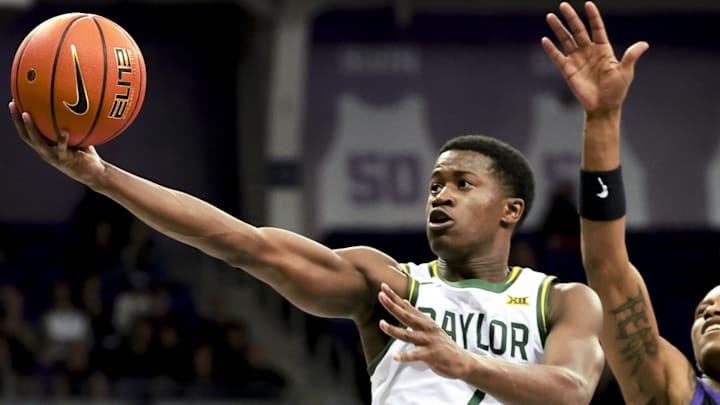 Mar 4, 2025; Fort Worth, Texas, USA;  Baylor Bears guard VJ Edgecombe (7) shoots past TCU Horned Frogs forward Trazarien White (13) during the second half at Ed and Rae Schollmaier Arena. Mandatory Credit: Kevin Jairaj-Imagn Images
