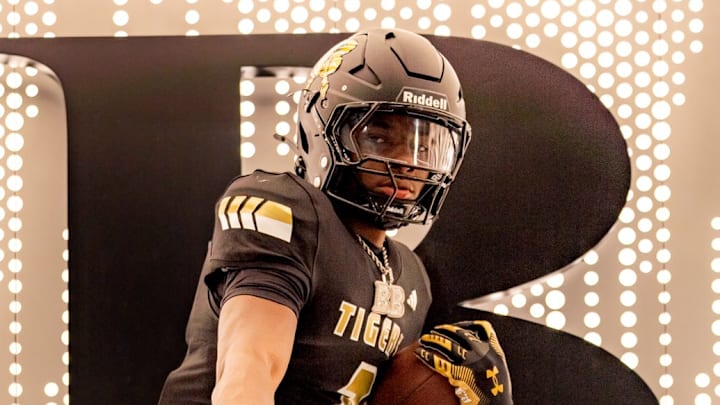 Junior defensive back Bryson Brown with the Heisman Trophy pose after announcing his decision to transfer to Broken Arrow High School in Oklahoma.