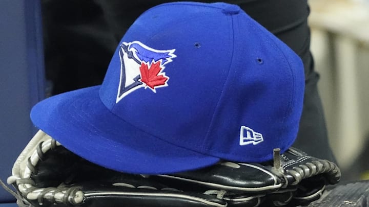 Apr 27, 2024; Toronto, Ontario, CAN; A Toronto Blue Jays hat and glove in the dugout during the third inning against the Los Angeles Dodgers at Rogers Centre.