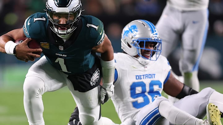Philadelphia Eagles quarterback Jalen Hurts (1) avoids the tackle against Detroit Lions linebacker Al-Quadin Muhammad (96)