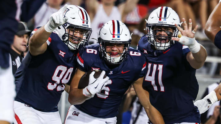 Aug 30, 2025; Tucson, Arizona, USA; Arizona Wildcats defensive lineman Mays Pese (99), linebacker Taye Brown (6), and defensive lineman Julian Saviinaea (41) all celebrate after they intercept the ball from the Hawaii Rainbow Warriors during the third quarter of the game at Arizona Stadium. Mandatory Credit: Aryanna Frank-Imagn Images