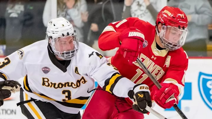 Denver senior forward Samu Salminen fights for the puck from Western Michigan junior defenseman Cole Crusberg-Roseen on Nov. 7, 2025