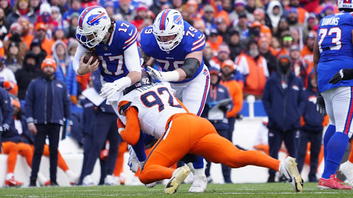 Jan 12, 2025; Orchard Park, New York, USA; Buffalo Bills quarterback Josh Allen (17) is sacked by Denver Broncos linebacker Dondrea Tillman (92) during the second quarter in an AFC wild card game at Highmark Stadium. 