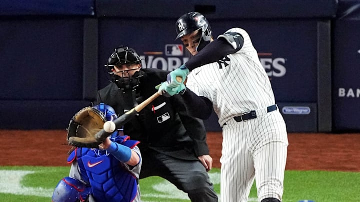 Oct 30, 2024; New York, New York, USA; New York Yankees outfielder Aaron Judge (99) hits a double during the eighth inning against the Los Angeles Dodgers in game four of the 2024 MLB World Series at Yankee Stadium.