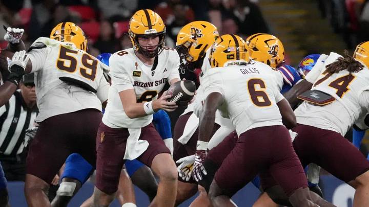 Arizona State Sun Devils quarterback Cutter Boley (8) hands the ball off to running back Marquis Gillis (6) against the Kansas Jayhawks during the second half at Wembley Stadium in London on Sept. 19, 2026.