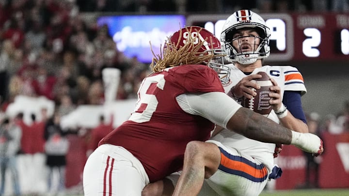 Nov 30, 2024; Tuscaloosa, Alabama, USA;  Alabama Crimson Tide defensive lineman Tim Keenan III (96) hits Auburn Tigers quarterback Payton Thorne (1)  for a loss during the second half at Bryant-Denny Stadium. Alabama won 28-14. Mandatory Credit: Gary Cosby Jr.-Imagn Images