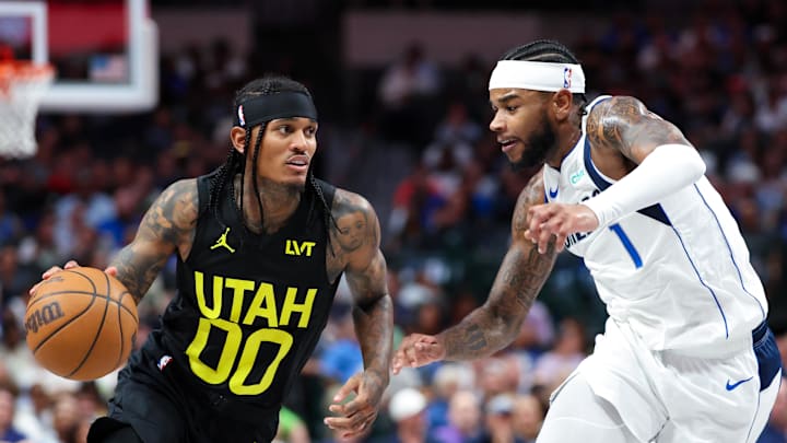 Oct 10, 2024; Dallas, Texas, USA;  Utah Jazz guard Jordan Clarkson (00) dribbles as Dallas Mavericks guard Jaden Hardy (1) defends during the second half at American Airlines Center. Mandatory Credit: Kevin Jairaj-Imagn Images