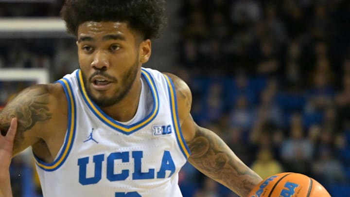 Jan 20, 2026; Los Angeles, California, USA;  UCLA Bruins guard Donovan Dent (2) drives past Purdue Boilermakers forward Trey Kaufman-Renn (4) in the first half at Pauley Pavilion presented by Wescom Financial. Mandatory Credit: Jayne Kamin-Oncea-Imagn Images