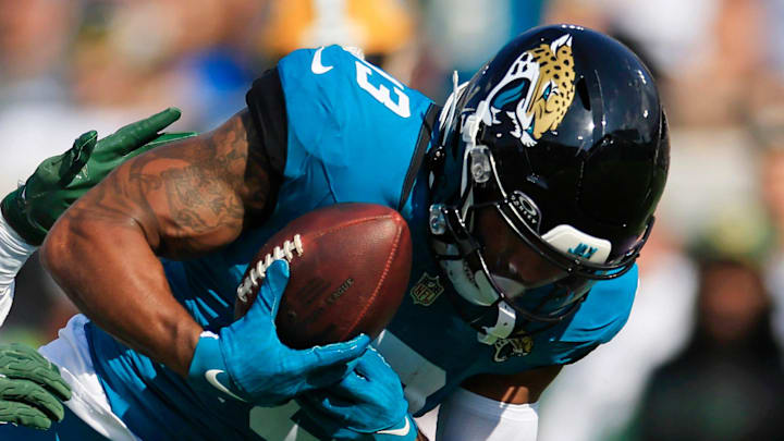 Green Bay Packers linebacker Edgerrin Cooper (56) tackles Jacksonville Jaguars wide receiver Christian Kirk (13) who can’t hang on to a pass and was apparently injured on the play and had to leave the game during the fourth quarter of an NFL football matchup Sunday, Oct. 27, 2024 at EverBank Stadium in Jacksonville, Fla. The Packers edged the Jaguars 30-27 on a last-second field goal. [Corey Perrine/Florida Times-Union]