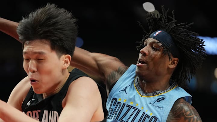 Portland Trail Blazers center Yang Hansen comes down with a rebound against Memphis Grizzlies forward GG Jackson. Portland Trail Blazers center Yang Hansen comes down with a rebound against Memphis Grizzlies forward GG Jackson.