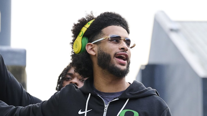 Nov 14, 2025; Eugene, Oregon, USA; Oregon Ducks quarterback Dante Moore (5) swipes his hand over the letter “O” during the “March to Victory” team walk before a game against the Minnesota Golden Gophers at Autzen Stadium. Mandatory Credit: Troy Wayrynen-Imagn Images