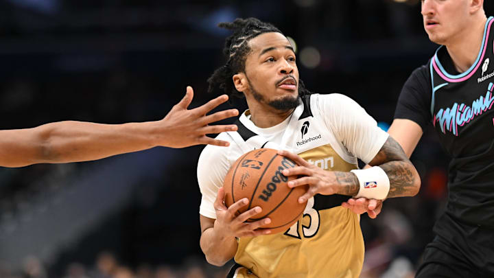 Feb 8, 2026; Washington, District of Columbia, USA;  Washington Wizards guard Sharife Cooper (13) drives between Miami Heat forward Myron Gardner (15) and forward Nikola Jovic (5) during the fourth quarter at Capital One Arena. Mandatory Credit: Rafael Suanes-Imagn Images